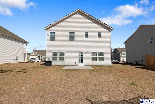 back of house featuring a patio, a yard, and central air condition unit