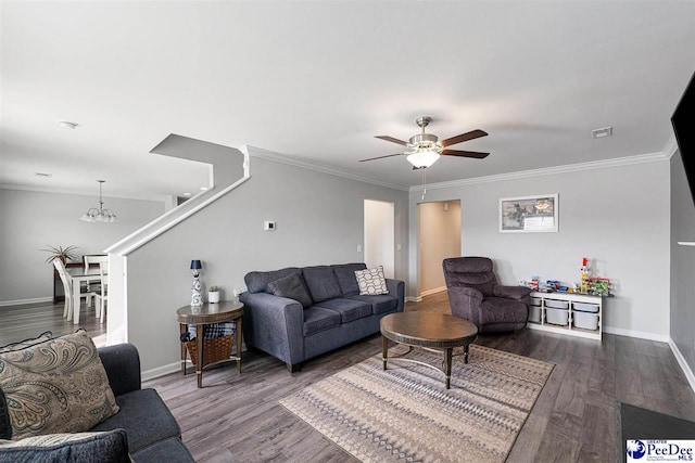 living room with baseboards, dark wood-style flooring, ceiling fan with notable chandelier, and crown molding