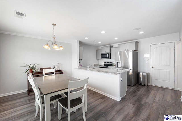 kitchen featuring appliances with stainless steel finishes, visible vents, and dark wood-style floors