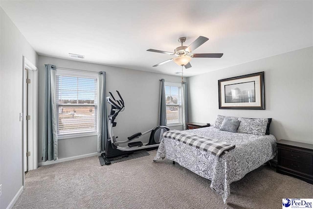 carpeted bedroom featuring ceiling fan, visible vents, and baseboards