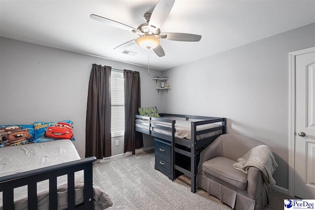 bedroom featuring ceiling fan, visible vents, baseboards, and light colored carpet