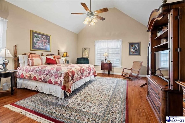 bedroom featuring hardwood / wood-style floors and high vaulted ceiling