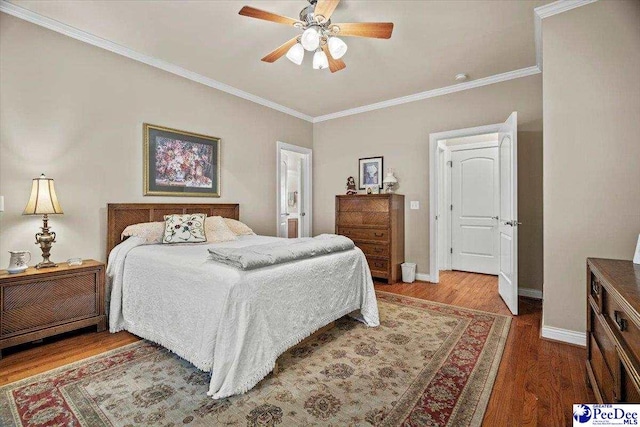 bedroom featuring crown molding, hardwood / wood-style floors, and ceiling fan