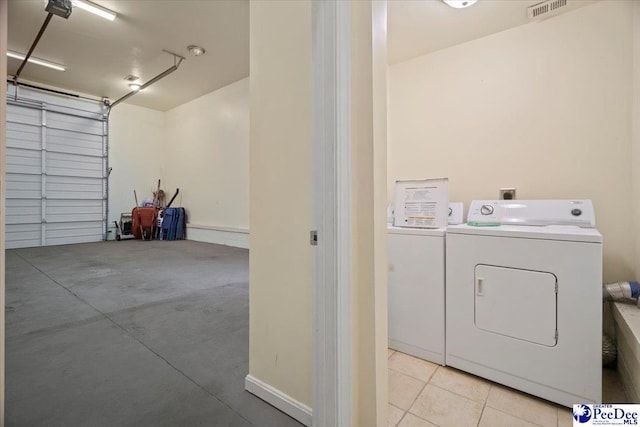 washroom with washing machine and clothes dryer