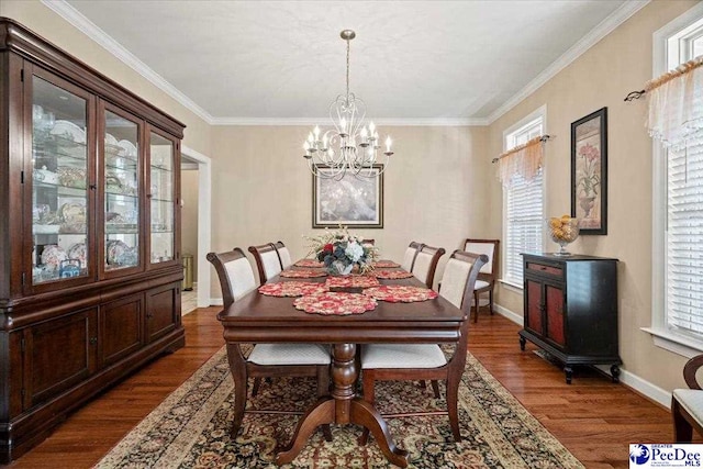 dining space featuring ornamental molding, a chandelier, and dark hardwood / wood-style flooring