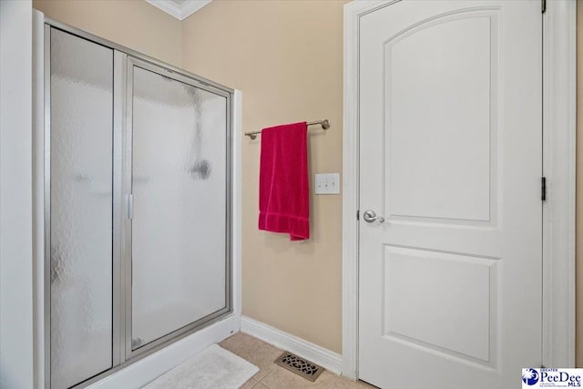 bathroom with tile patterned flooring and walk in shower