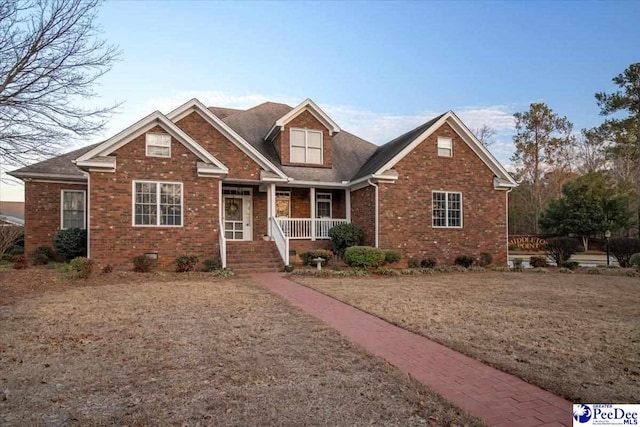 view of front of property with covered porch and a front yard