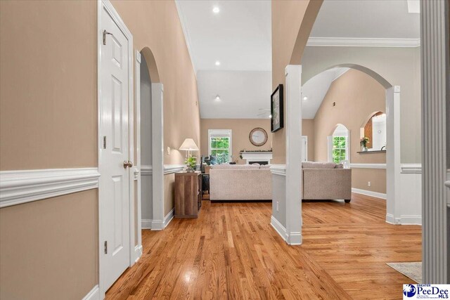 1850 Wax Myrtle Dr, Florence, SC 29501 - hall featuring arched walkways, plenty of natural light, ornamental molding, light wood-style floors, and lofted ceiling