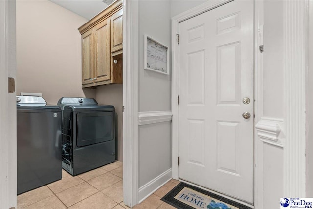 1850 Wax Myrtle Dr, Florence, SC 29501 - laundry room featuring independent washer and dryer, light tile patterned floors, cabinet space, and baseboards