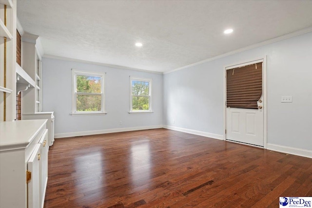 unfurnished living room with crown molding and dark wood-type flooring