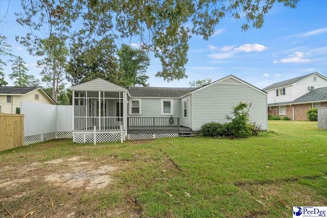 back of property featuring a sunroom, a yard, and a deck