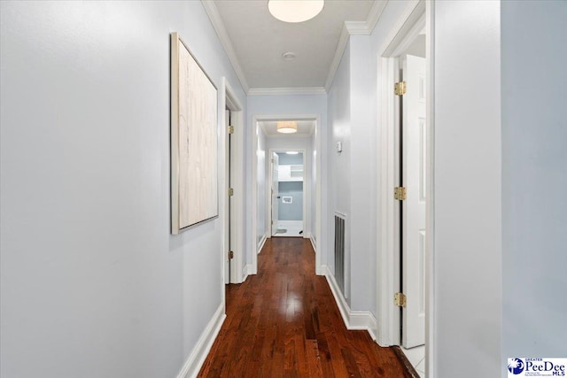 hallway featuring ornamental molding and dark wood-type flooring