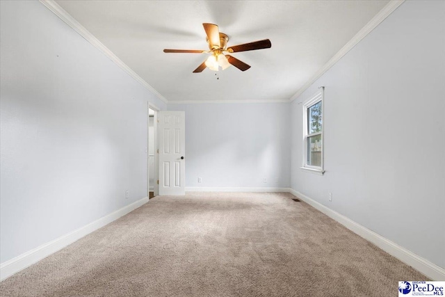 empty room featuring crown molding, light colored carpet, and ceiling fan