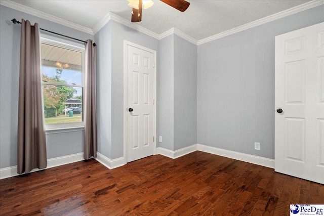 unfurnished bedroom with ornamental molding, ceiling fan, and dark hardwood / wood-style flooring