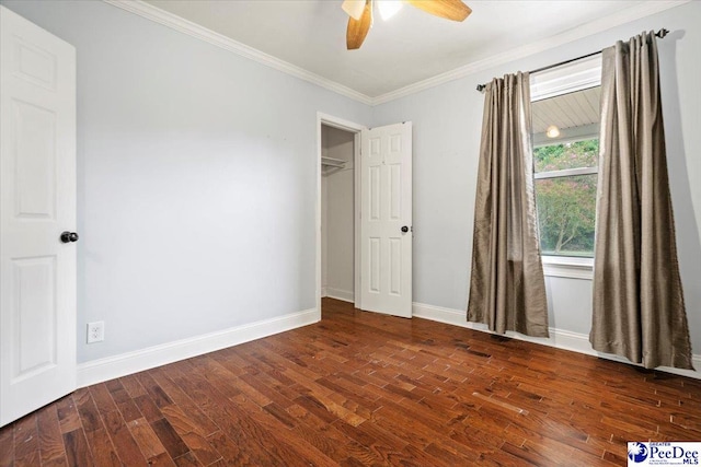 unfurnished bedroom featuring ornamental molding, dark hardwood / wood-style floors, and ceiling fan