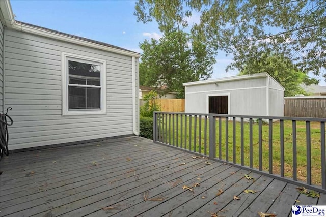 wooden deck with a yard and a shed