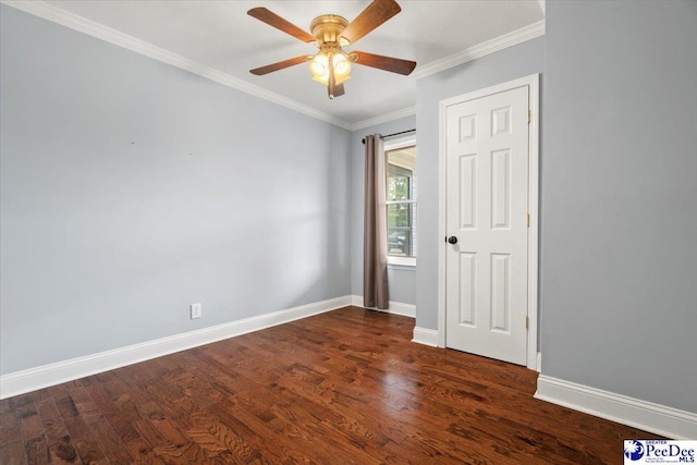 empty room with dark hardwood / wood-style flooring, ornamental molding, and ceiling fan