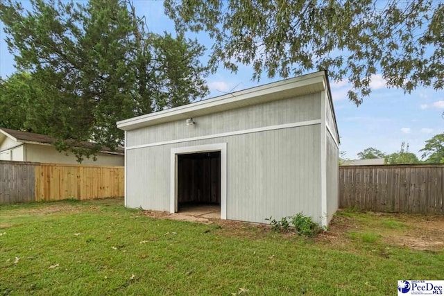 view of outbuilding with a lawn