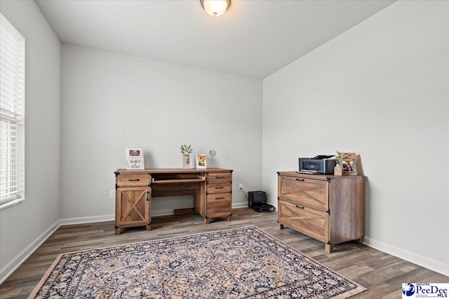 office space featuring baseboards and wood finished floors