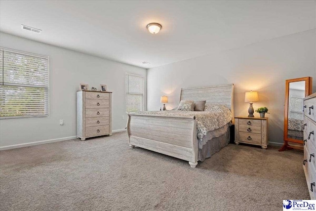 bedroom featuring baseboards, visible vents, and carpet flooring