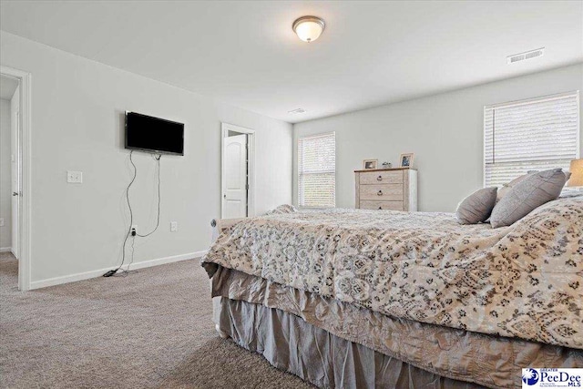 carpeted bedroom with baseboards and visible vents