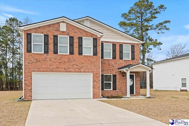 view of front of home with driveway, a front lawn, an attached garage, and brick siding