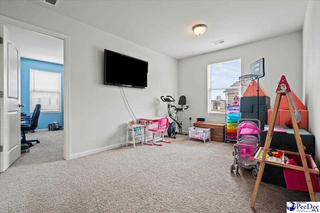 recreation room with carpet floors, visible vents, and baseboards