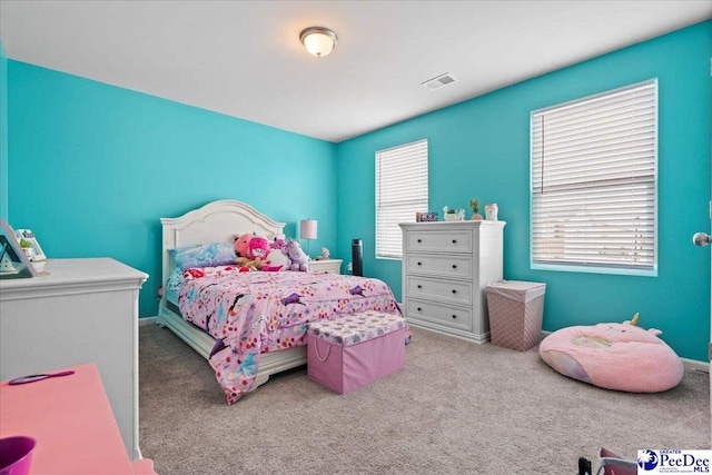 bedroom with carpet floors, baseboards, and visible vents