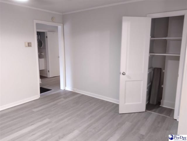 unfurnished bedroom with crown molding and light hardwood / wood-style floors