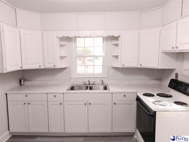 kitchen with sink, range with electric stovetop, light stone countertops, and white cabinets