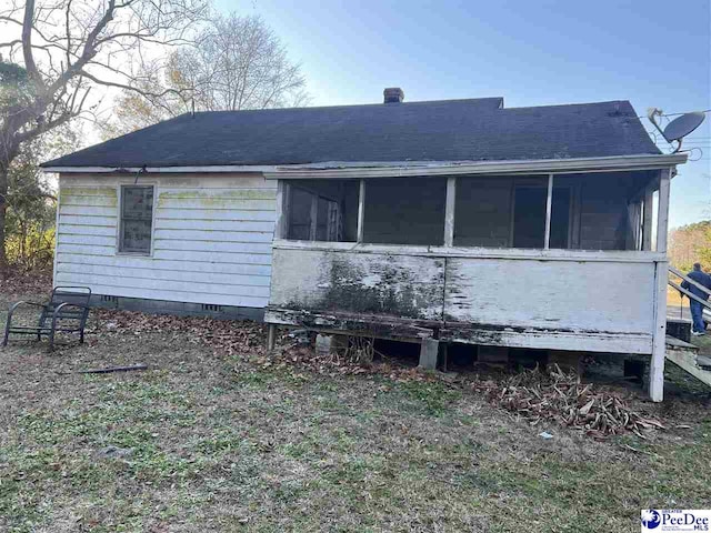 rear view of house with a sunroom