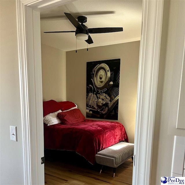 bedroom with wood finished floors and a ceiling fan