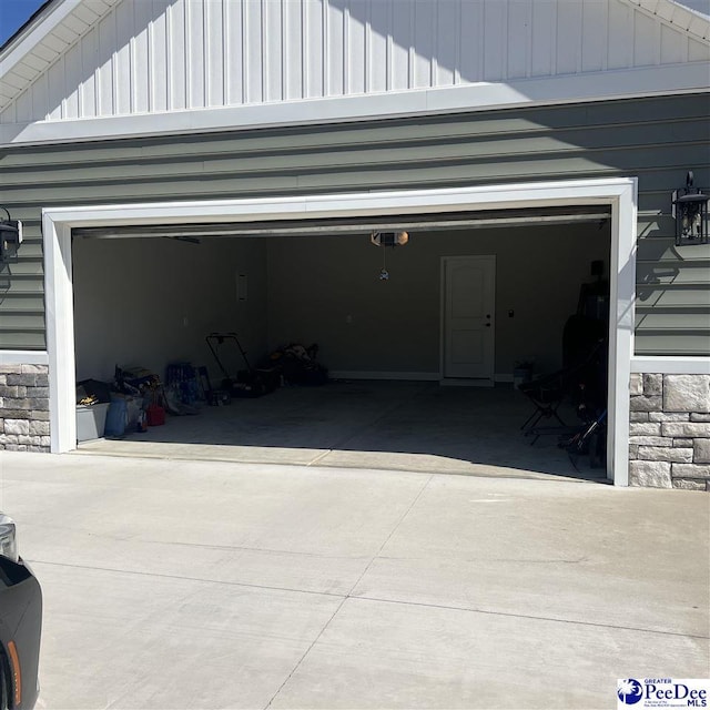 garage featuring concrete driveway and a garage door opener