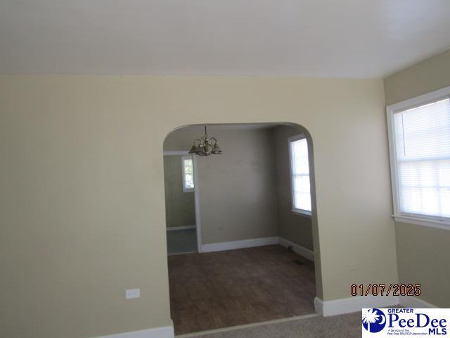 empty room with a notable chandelier