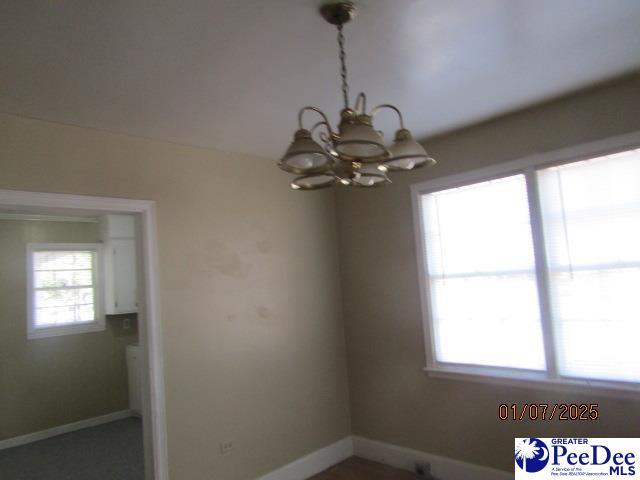 spare room with an inviting chandelier