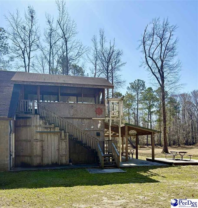 exterior space with a lawn and stairway