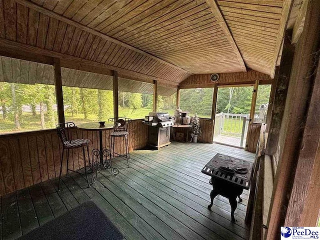 sunroom featuring lofted ceiling and wood ceiling