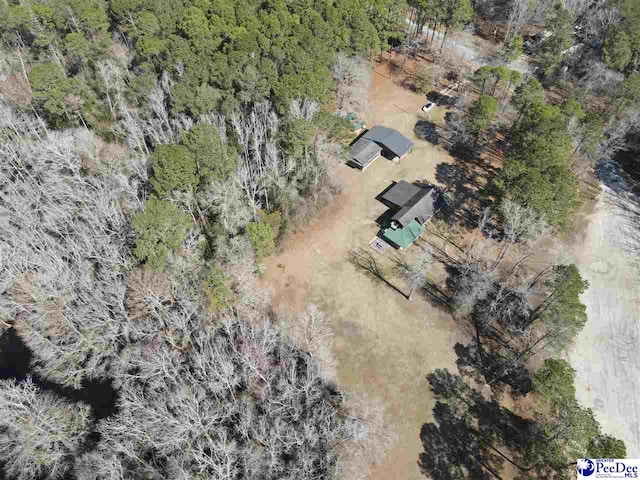 birds eye view of property featuring a wooded view