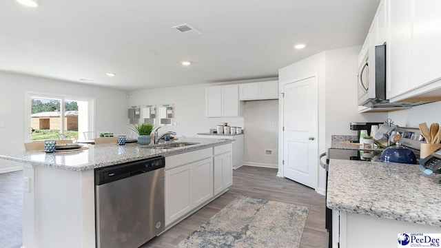 585 Strawberry Field Way, Galivants Ferry, SC 29544 - kitchen with appliances with stainless steel finishes, a sink, white cabinets, light stone countertops, and a center island with sink