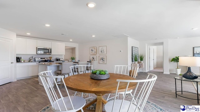 585 Strawberry Field Way, Galivants Ferry, SC 29544 - dining area with light wood-style flooring, recessed lighting, and baseboards