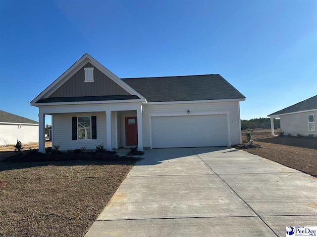 585 Strawberry Field Way, Galivants Ferry, SC 29544 - view of front of property featuring a garage, concrete driveway, a porch, and board and batten siding
