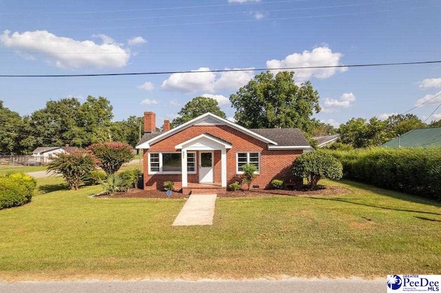 bungalow-style home with a front lawn