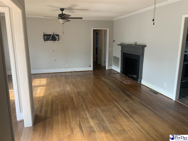 unfurnished living room featuring ceiling fan, dark hardwood / wood-style flooring, ornamental molding, and a fireplace