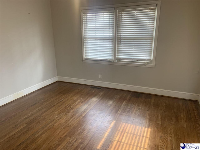 empty room featuring dark wood-type flooring