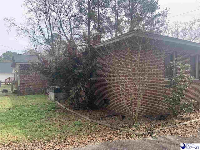 view of side of home featuring a yard