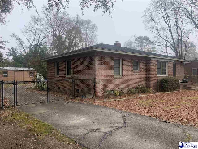 view of property exterior with a shed