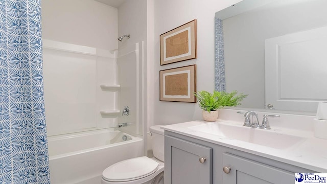bathroom featuring toilet, tub / shower combination, and vanity