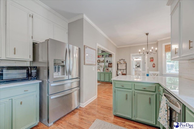kitchen featuring green cabinets, a peninsula, stainless steel refrigerator with ice dispenser, light countertops, and a notable chandelier