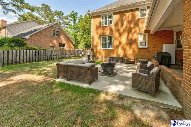 view of patio with grilling area, an outdoor hangout area, and a fenced backyard