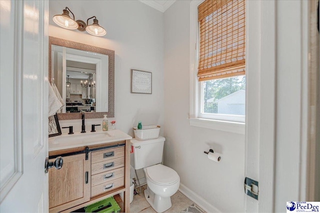 half bathroom with vanity, baseboards, and toilet